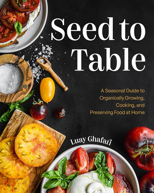 Cover of the book 'Seed to Table' by Luay Ghafari. The cover features a dark background with vibrant, colorful tomatoes, fresh basil leaves, a bowl of coarse salt, and a slice of bread with tomato and basil garnish. The title and subtitle, 'A Seasonal Guide to Organically Growing, Cooking, and Preserving Food at Home,' are prominently displayed in white text.